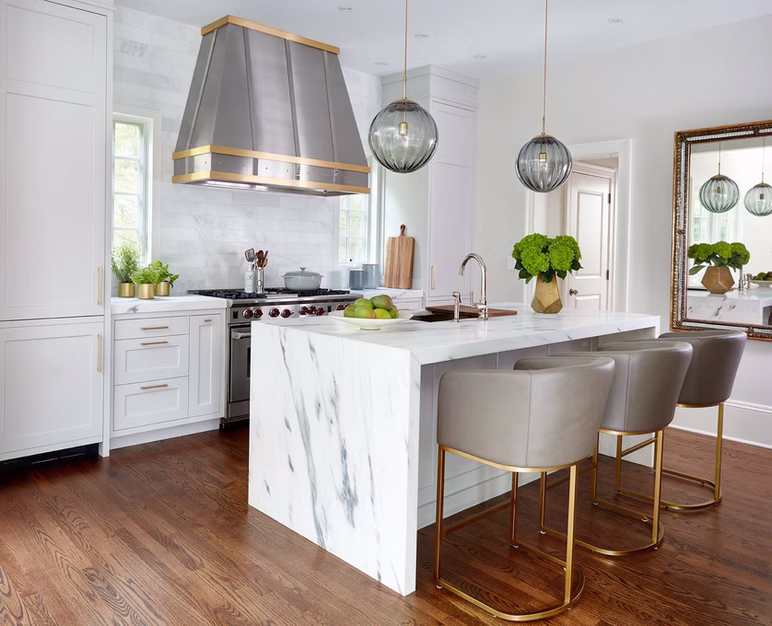 White inset style kitchen cabinets with metal range hood.